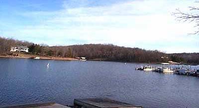 Aerial view of Cherokee Village in Fulton County, Arkansas, showing a .25-acre lot across from the lake, offered by Onlinelandsales.