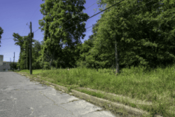 Aerial view of Arkansas Jefferson County 0.25-acre Harding Henry Block 6 Lot 5 land parcel, with surrounding properties and terrain.