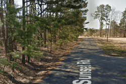 Aerial view of a 0.14-acre Pine Bluff lot in Jefferson County, Arkansas, showing property boundaries and surrounding area.