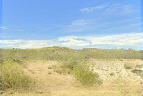 Aerial view of Arizona Starlight Hills 1.25-acre land lot in Mohave County, showing rugged desert terrain and surrounding landscape.