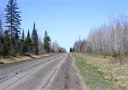 Aerial view of Michigan's Baraga County 20-acre Abby Point land for sale, showing wooded terrain and water access.