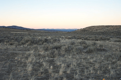 Aerial view of Nevada Elko County 10-acre Gamble District land parcel, section 21, NE4NE4SW4, with surrounding desert landscape.