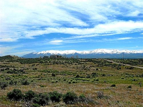 Aerial view of Nevada Elko County Meadow Valley Ranchos 1.13-acre land parcel, showing open desert landscape and surrounding terrain.
