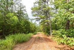 Aerial view of Oklahoma Latimer County 20.23-acre Stone Bridge V lot with surrounding natural landscape and open land.