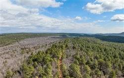 Aerial view of Oklahoma Latimer County Stone Bridge III 17.94-acre lot, featuring natural landscape and wooded areas.