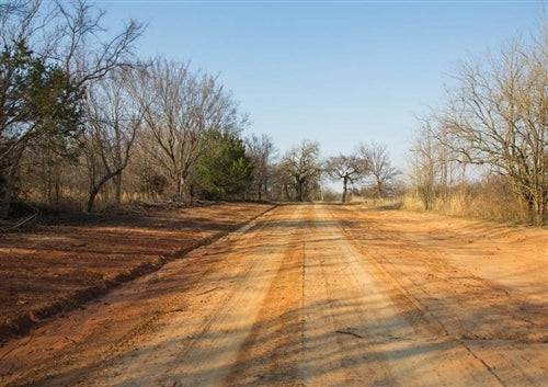 Aerial view of Pittsburg County Eufaula Estates Lot 9 in Oklahoma, showing wooded land with electrical access and surrounding nature.
