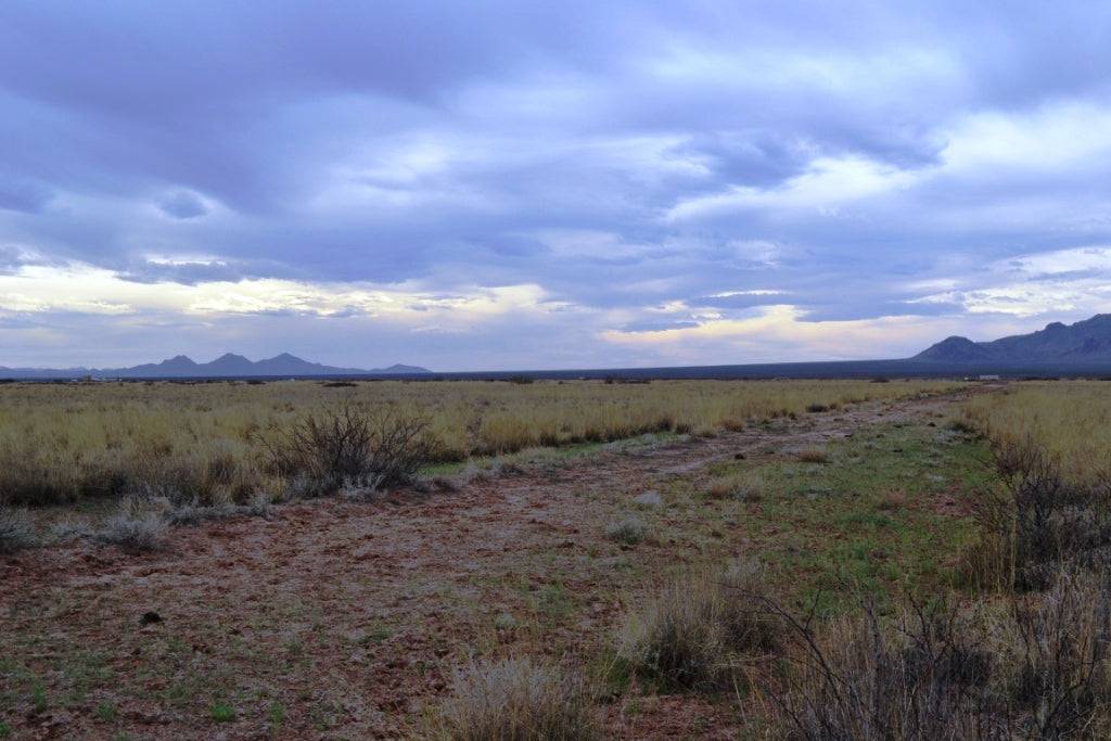 Aerial view of two adjoining 1-acre lots in Sunshine Valley Ranchettes, Luna County, New Mexico, with desert terrain and clear skies.
