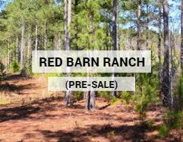 A scenic view of the Benton County Red Barn Ranch with open land and a red barn, showcasing the 5-13 acre property in Tennessee.
