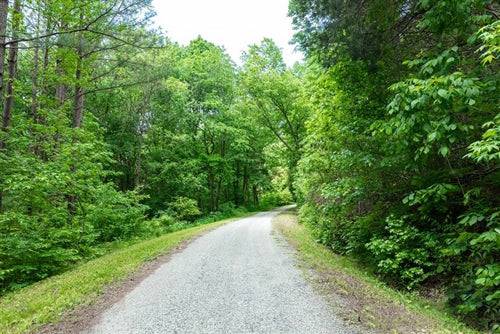 Aerial view of TN Cedar Creek Lot 30, a 6.13-acre property in Perry County, Tennessee with lush greenery and wooded landscape.