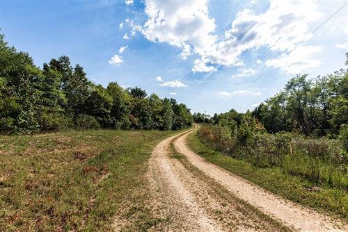 Aerial view of Redemption Ridge Lot 10, 5.16-acre land in Wayne County, Tennessee, with natural landscape and surrounding trees.