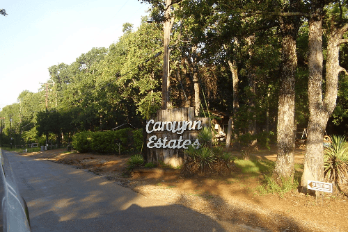 Aerial view of Carolyn Estates Lot 21 in Henderson County, Texas, featuring Cedar Creek Reservoir surroundings and electrical hookup.