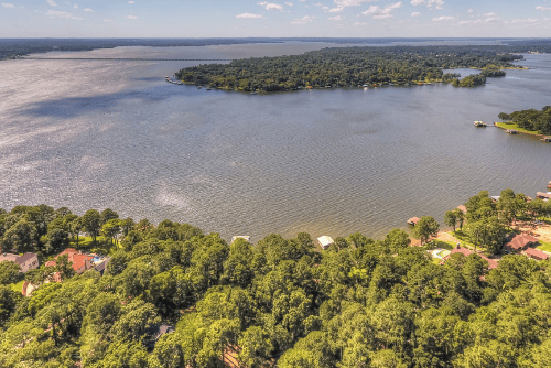 Aerial view of Henderson County Lake Palestine lot 154 at Westwood Beach, showing surrounding water and land with nearby electrical access.
