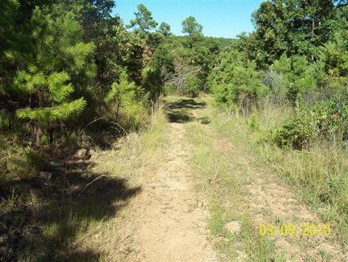 Aerial view of Pine Mountain Ranch in Latimer County, Oklahoma, showcasing 5 acres of wooded land with surrounding natural landscape.