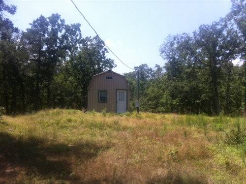 Lake view ranch with cabin, creek, and electricity in Pushmataha County, Oklahoma; 9.94 acres, ideal for outdoor living.