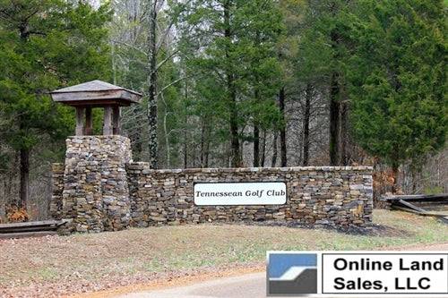 Aerial view of a .61-acre land lot in Henry County, Tennessee, with views of surrounding terrain, nearby golf course, and utility access.