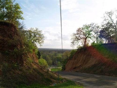 A scenic view of Bastrop County, Texas, showcasing Tahitian Village Resort land parcel with lush greenery and natural landscape.
