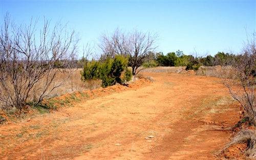 Aerial view of Texas Knox County Red Rock Ranch Lot 13, 21.74-acre rural land parcel with natural red rock terrain.