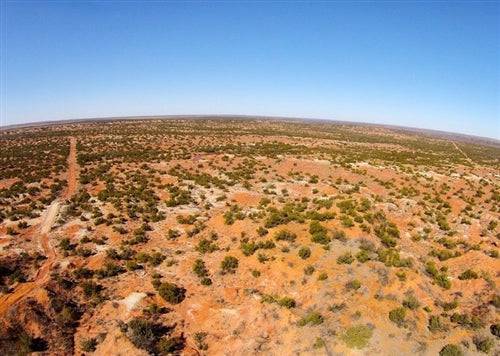 Aerial view of Texas Knox County Red Rock Ranch, a 19.26-acre property with red rock terrain and open land.