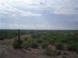 Aerial view of Texas Reeves County 70-acre land near Pecos with open fields and rural landscape.