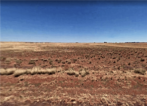 Aerial view of Arizona Navajo County 1.26-acre ranch lot 49 with open landscape and clear skies in Arizona.
