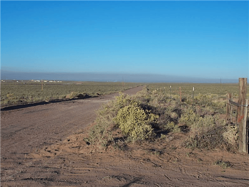 Aerial view of Arizona Navajo County ranch lot 68 and 67, 1.33 acres, with surrounding desert landscape and clear blue sky.
