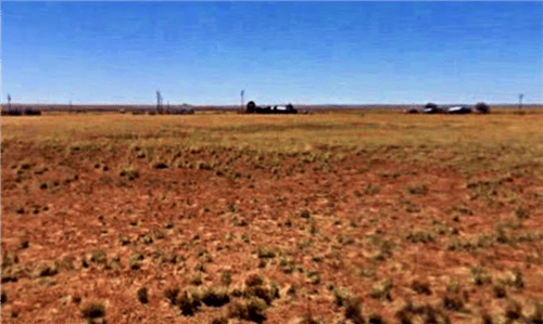 Aerial view of Navajo County Arizona ranch lot 92, 1.25 acres, showing open land with sparse desert vegetation.