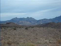 Aerial view of 1.25-acre Lake Mohave Heights land in Mohave County, Arizona, with surrounding desert landscape and distant mountains.