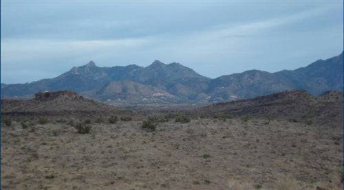 Aerial view of 1.25-acre Lake Mohave Heights land in Mohave County, Arizona, with surrounding desert landscape and clear skies.