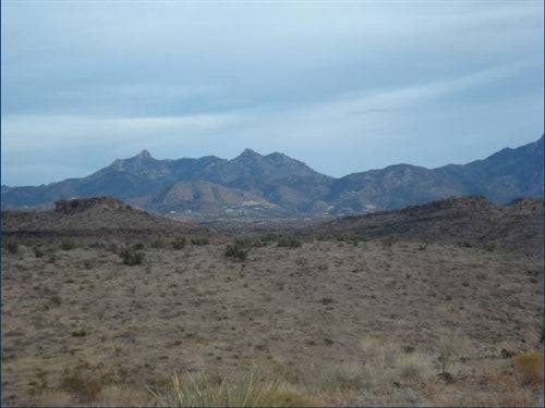 Aerial view of 1.25-acre Lake Mohave Heights land in Mohave County, Arizona, with surrounding desert and distant mountains.