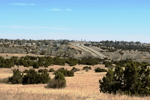 Aerial view of Colorado Pueblo County 1.92-acre city lot with visible land boundaries and surrounding area, featuring nearby electricity access.