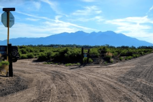 Aerial view of Colorado Fremont County 4.79-acre land parcel in Sec. 12, showcasing small gullies and surrounding terrain.