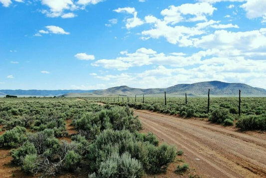 Aerial view of Utah Iron County Garden Valley Ranchos Unit 5 Lot 2586, showing open land with surrounding natural landscape.