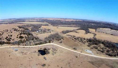 Aerial view of Kansas Cowboy Meadows property in Chautauqua County with open land, showing utilities and surrounding countryside.