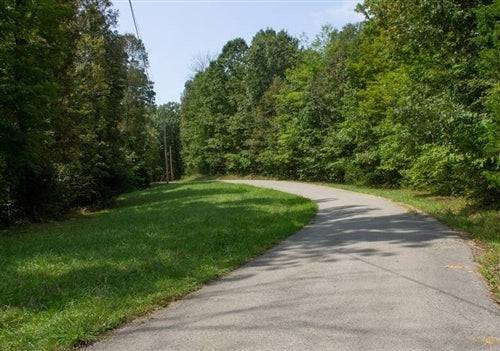 Aerial view of Bluegrass Ridge Lot 12 in Wayne County, Kentucky, showing open 9.30-acre bluegrass farmland under clear skies.