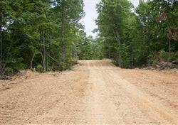 Aerial view of Buck Run Ridge Lot 14, an 11.50-acre property in Wayne County, Kentucky, with wooded terrain and open land.