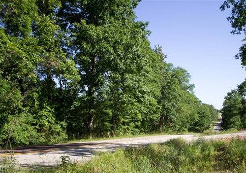Aerial view of Missouri Douglas County Timber Crossing Lot 29 showing wooded 16-acre property with natural landscape and surrounding trees.