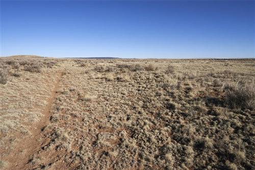 Aerial view of New Mexico Torrance County Estancia Ranchettes Lot 22, a 0.83-acre parcel of land with open desert landscape.