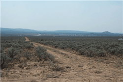 A mountain view of Tres Piedras in Taos County, New Mexico, showing a 0.25-acre land lot with natural landscape and open sky.