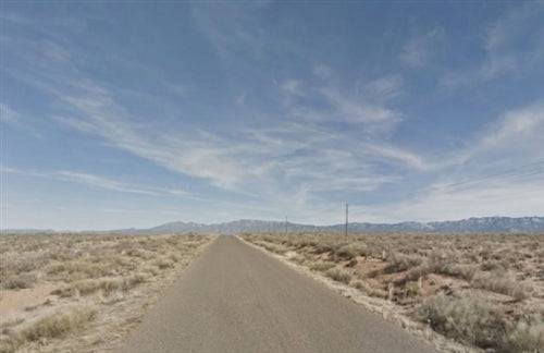 Aerial view of New Mexico Valencia County Rio Del Oro Lot 30, a 0.25-acre parcel of land with natural desert terrain.