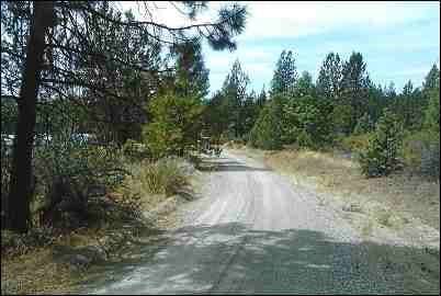 Aerial view of Oregon Klamath County 2.18-acre forest estate lot in Klamath Falls, showing wooded land and surrounding nature.