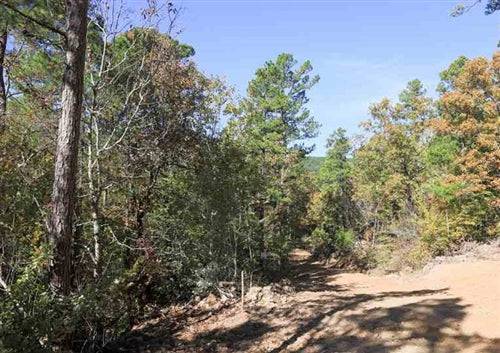 Aerial view of Oklahoma Latimer County Stone Creek Phase I Lot 170, showing wooded 26.9-acre property with natural landscape.