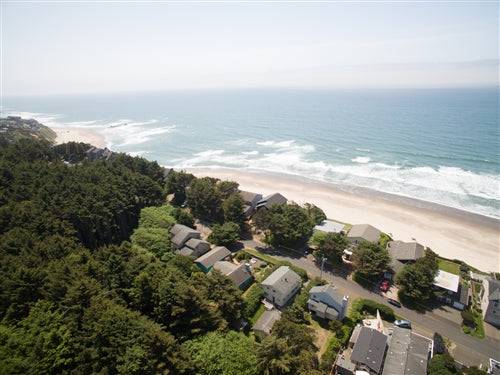 Sea Base Oregon beach house exterior with deck and ocean view, available for a one-month rental deposit.