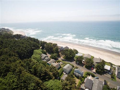 Sea Base Oregon beach house exterior with deck and ocean view, available for a one-month rental deposit.
