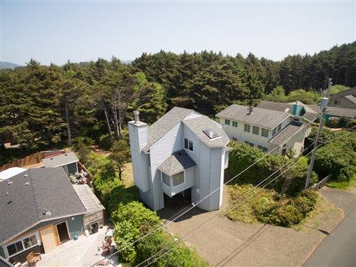 Oceanfront Oregon beach house rental deposit from Sea Base Oregon, showing a cozy coastal home with a sandy beach view.