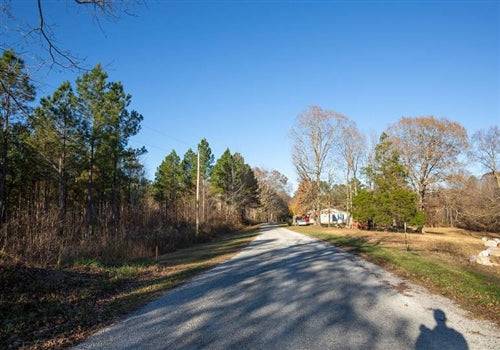 Aerial view of Whetstone Pines Lot 3 in Decatur County, Tennessee, showing wooded 8.33-acre land with some electrical infrastructure.
