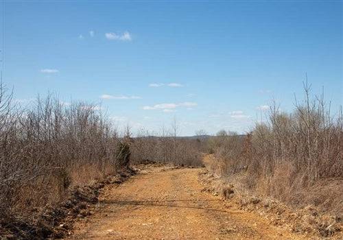 Aerial view of Tennessee Perry County Southwind Ranch Lot 5, 9.81-acre land parcel with open fields and rural landscape.