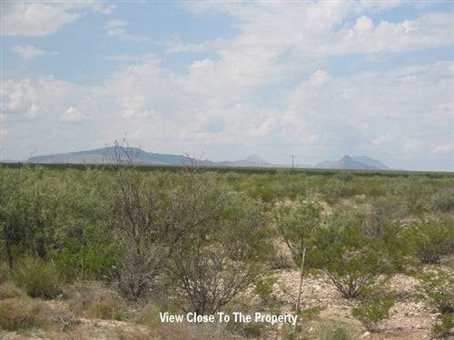 Aerial view of Texas Hudspeth County 5-acre land parcel for sale by Onlinelandsales, showing open desert terrain and distant mountains.