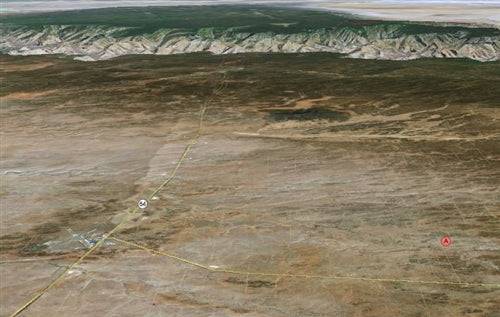 Aerial view of 1-acre Grand Canyon Estates in Coconino County, Arizona, with rugged landscape and surrounding natural scenery.