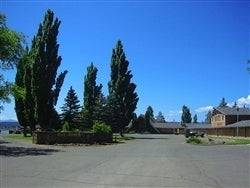 Aerial view of a 1-acre property in Modoc County, California Pines Resort, showing pine trees and natural landscape.