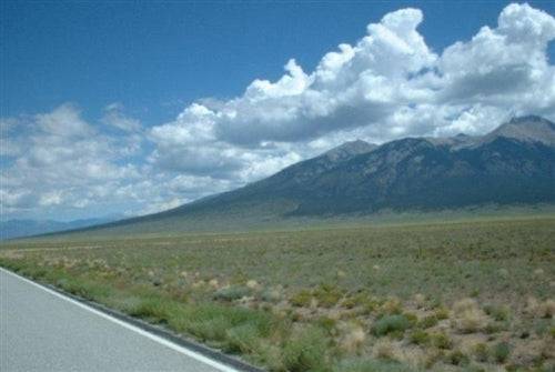 Aerial view of Colorado Alamosa County Mount Blanca Valley Ranches showing open 5-acre lot with mountain scenery.